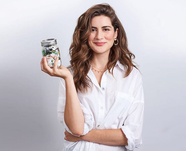 Lauren Singer of Low Waste Living holding a mason jar of trash Important Stories of 2018